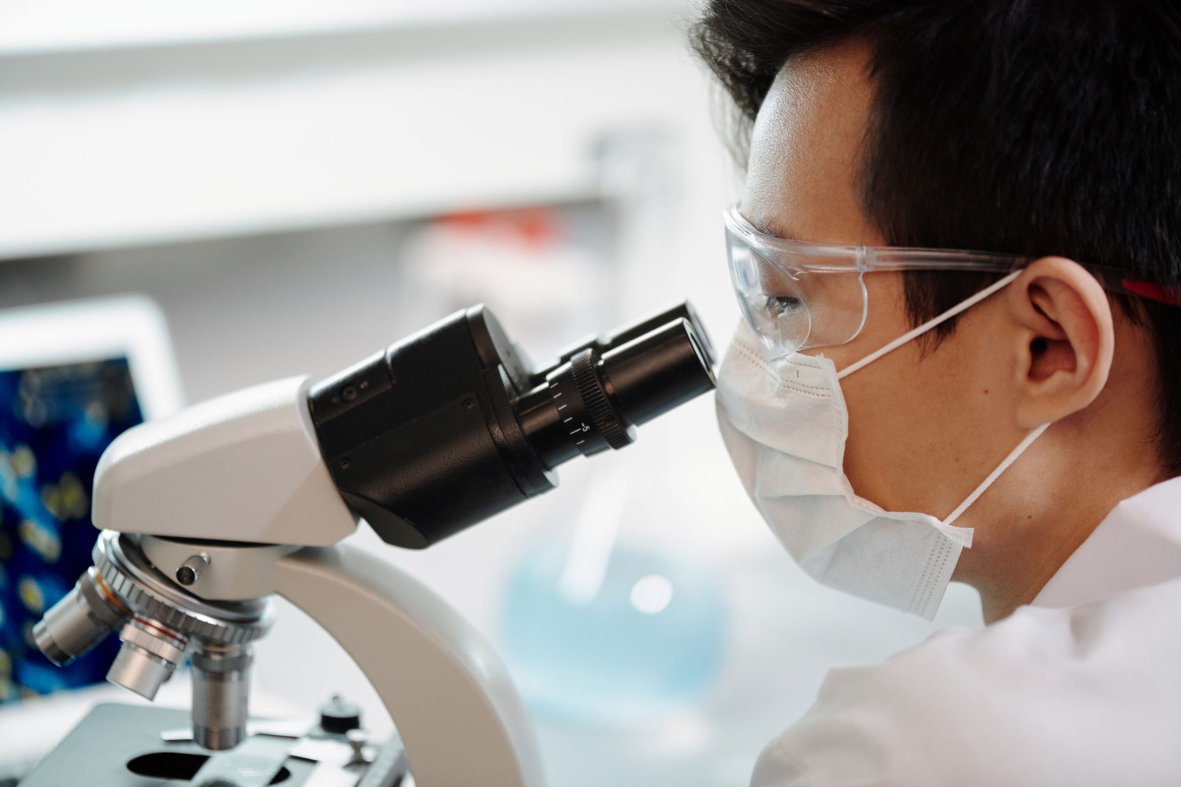 A scientist looking into a microscope