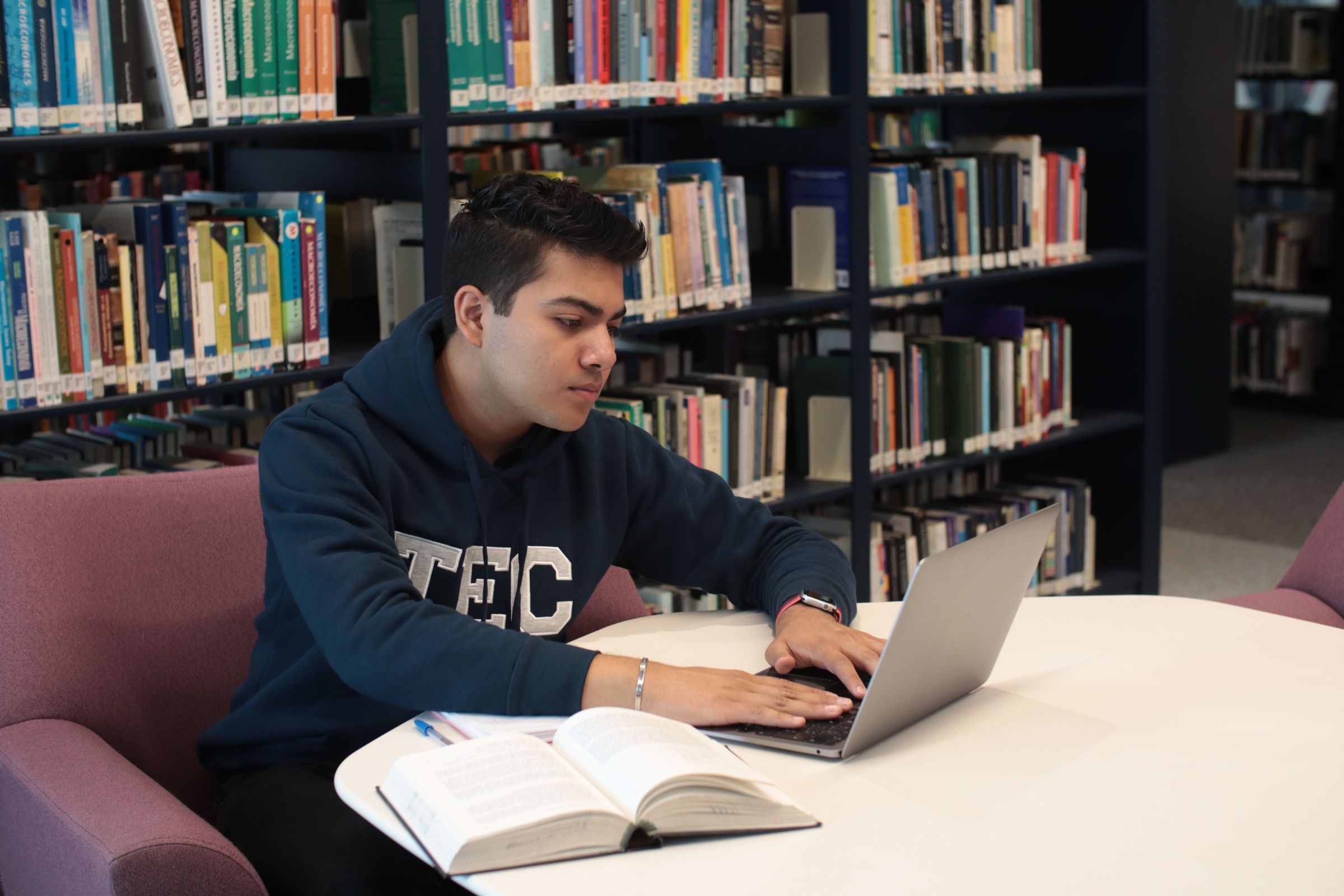 A student searching library shelves